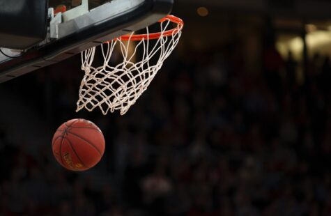 Basketball being thrown through the hoop
