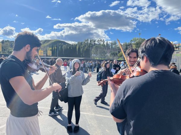 Students play the violin during an evacuation to the blacktop for an earthquake on February 9th, 2024.