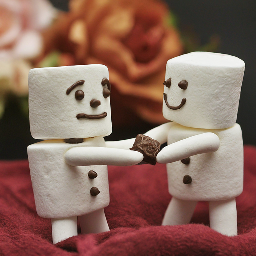 Marshmellow men giving each other chocolates, not in a romantic way, but in a friendly way.